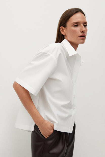 White short-sleeve button-up shirt with pointed collar, side view