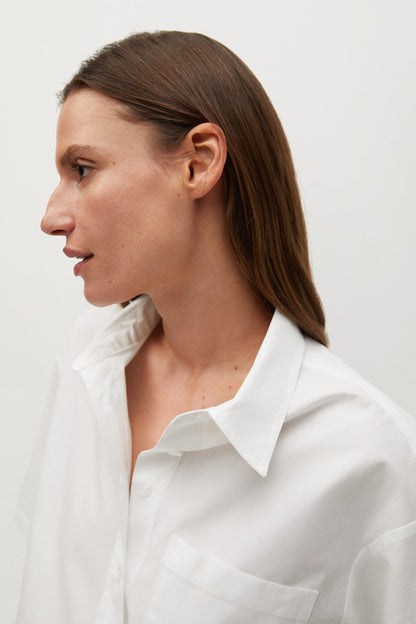 White button-up shirt neckline with pointed collar and visible front placket