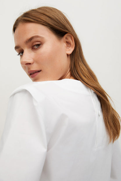 MANGO white blouse detail, short sleeve and shoulder seam close-up
