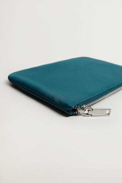Petrol blue zip pouch corner with metal zipper pull and stitching