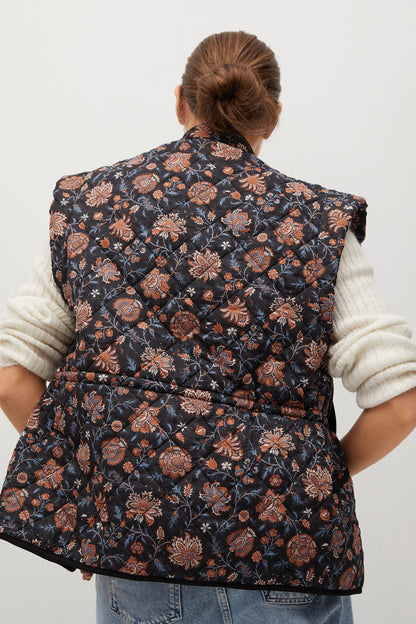 Navy floral sleeveless quilted vest, full back view with stitched panel detail