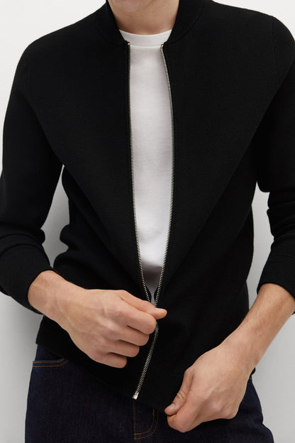 Black zip-up jacket front detail with silver chain zipper