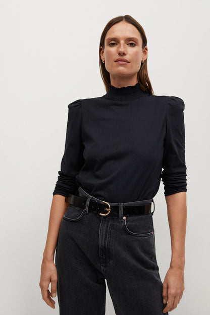 Black knit turtleneck top with puff shoulders and long sleeves