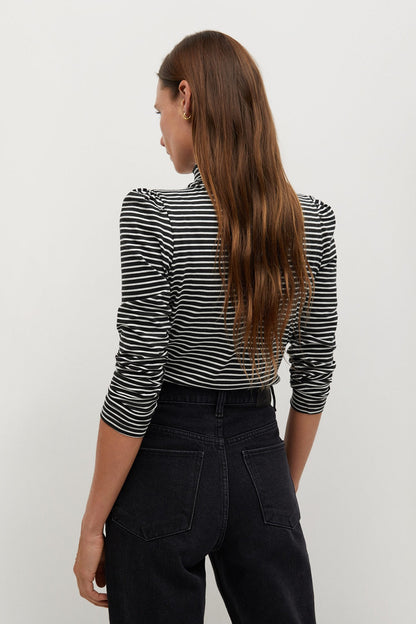 Back view of striped turtleneck top in off-white and dark with long sleeves