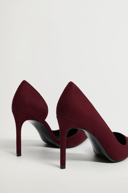 Pair of wine pointed-toe stiletto heels, angled view showing dark sole