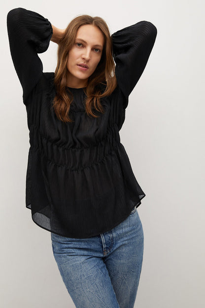 Black gathered blouse with puff sleeves and elastic waist, front view