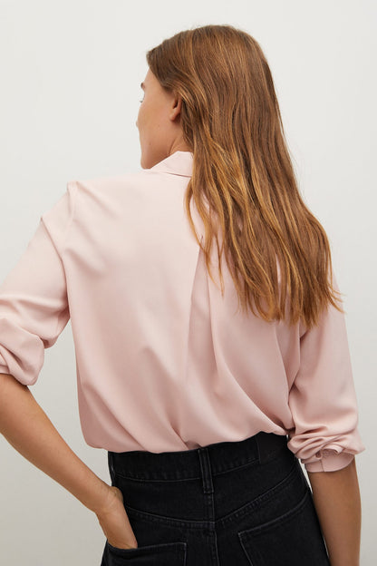 Light pink blouse with pointed collar and long sleeves, relaxed fit