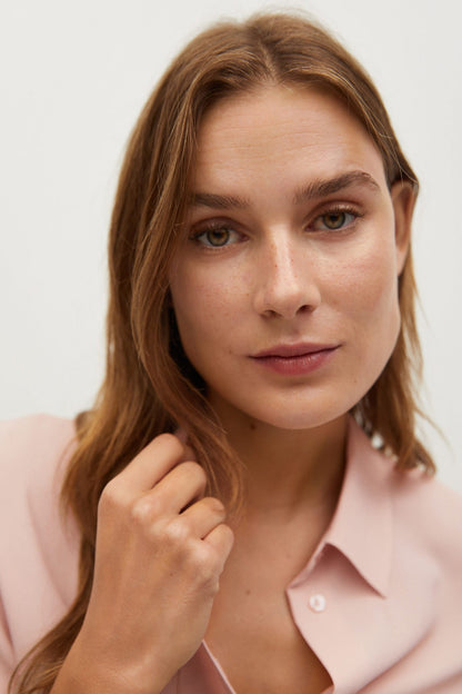 Light pink blouse collar and button placket, close-up