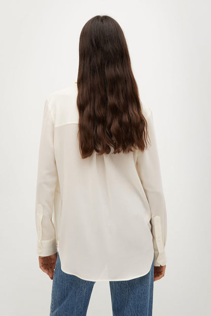 Ecru long-sleeve button-up shirt shown from the back, collar and yoke visible