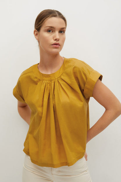 Mustard yellow short-sleeve blouse with gathered neckline and loose drape