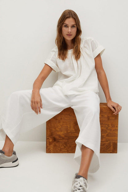 White short-sleeve blouse and matching wide-leg pants