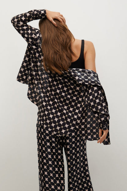 Black circle-print jacket with wide sleeves and waist tie, side view