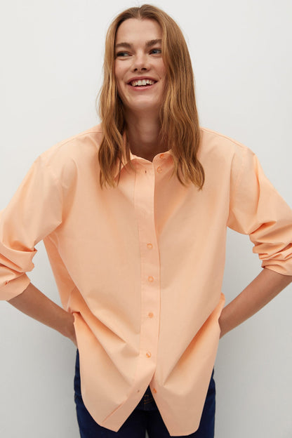 Coral button-up shirt with short sleeves, front buttons, and curved hem