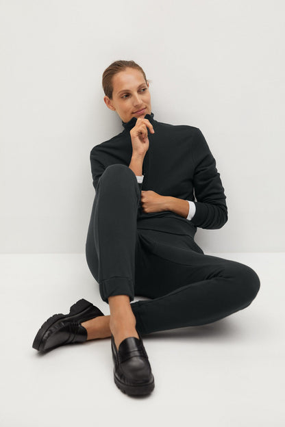 Charcoal tapered track pants with ankle cuffs, front view