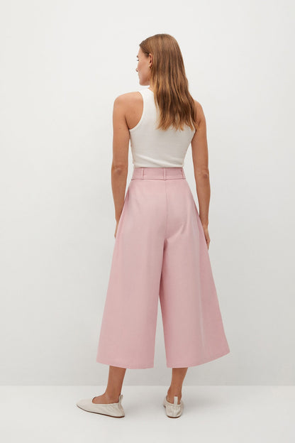 Back view of pink midi dress with white sleeveless top and belted waist