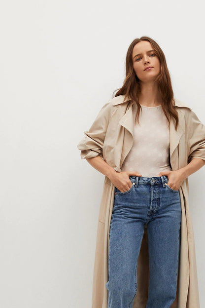Ecru long-sleeve crew-neck top under open beige coat