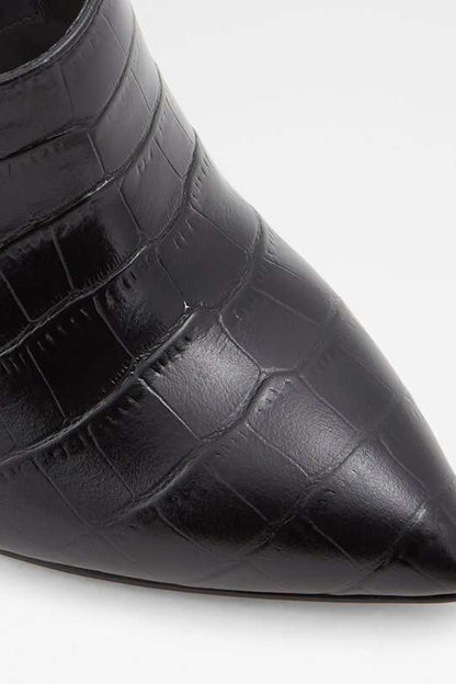 Close-up of black croc-embossed pointed toe on heeled mule