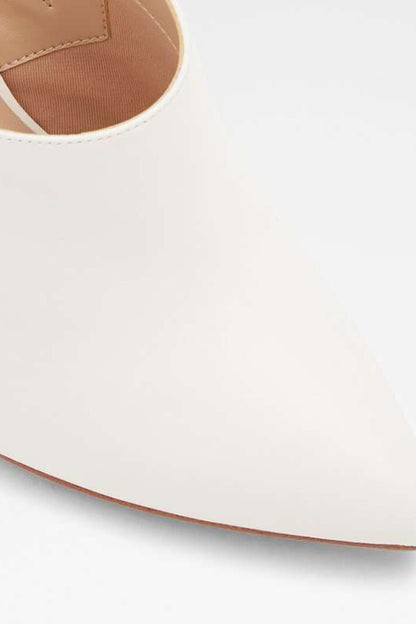 White mule upper close-up with tan stitching and curved outsole edge