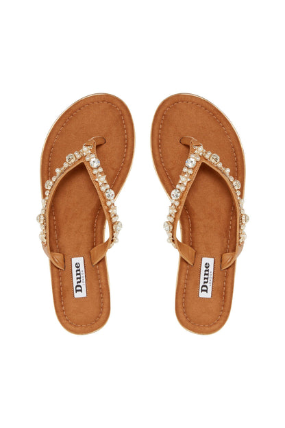 Pair of tan flip-flops with crystal and pearl T-strap and Dune London tag