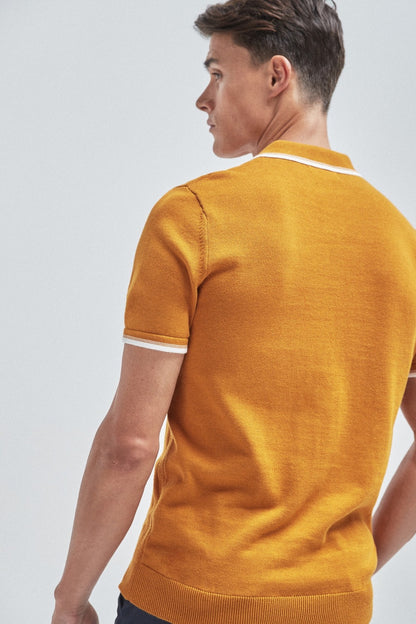 Amber ribbed knit polo shirt, short sleeves with white-trim collar, back view