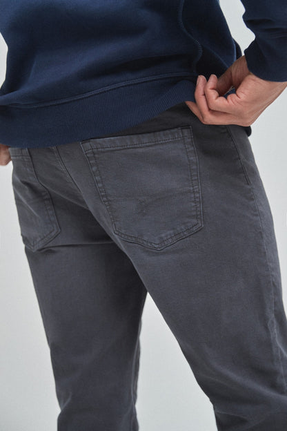 Navy jeans close-up with stitched front pockets and side seam