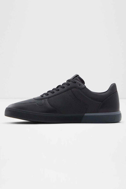 Black low-top lace-up sneakers, angled profile with lace eyelets and stitching