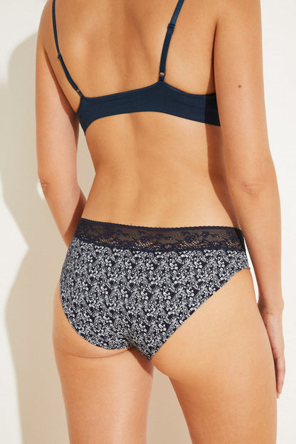 Medium-blue bralette with thin straps and lace trim, paired with bikini briefs