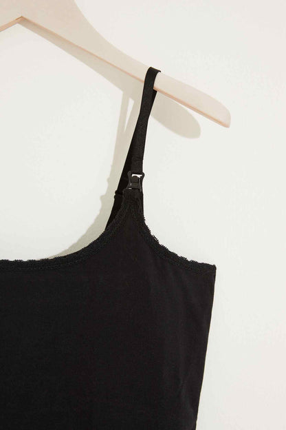 Black camisole strap with adjustable hardware and lace-trim neckline
