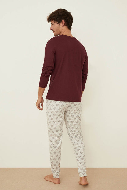 Men's pajama set with maroon long-sleeve back and white patterned drawstring pants