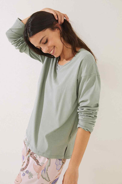 Women's green long-sleeve top with lace-trim neckline, relaxed fit