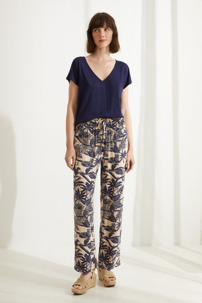Navy V-neck pajama top with tropical print pajama pants, full-body view
