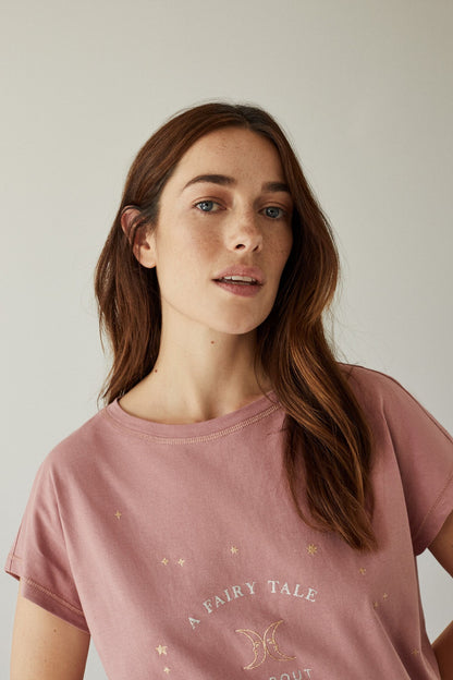 Women's pink pajama set top: close-up of short sleeves and star logo print