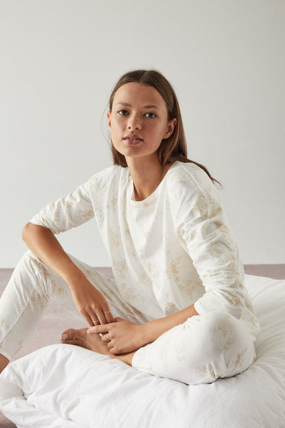 Women's Secret white pajama set with brown print, long-sleeve top and relaxed pants