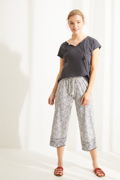 Charcoal grey short-sleeve pajama top and printed capri pants, side view
