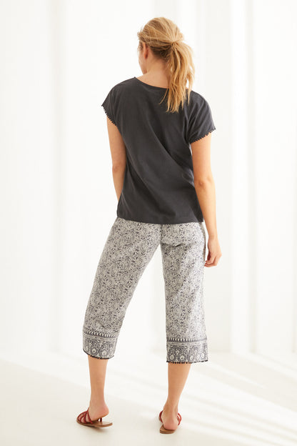 Charcoal grey pajama top and printed capri pants, back view
