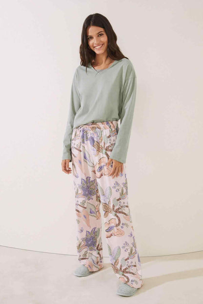 Light pink printed pajama pants with elastic smocked waistband and relaxed straight fit