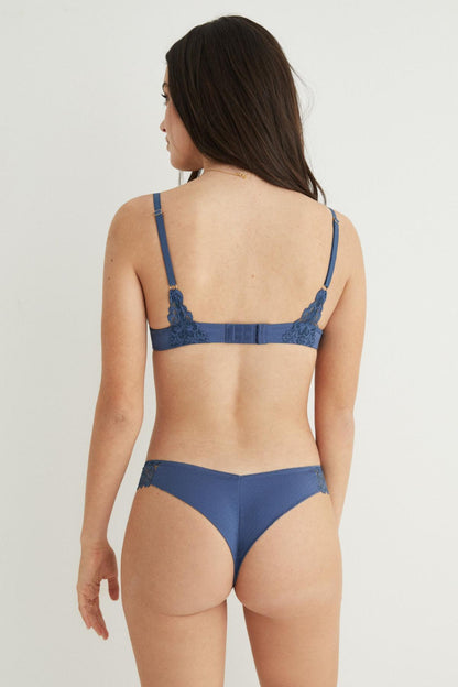 Back view medium blue lace bra with lace-trim briefs