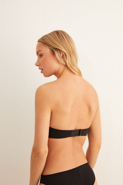 Black underwired bra with thin straps and bikini briefs, side view