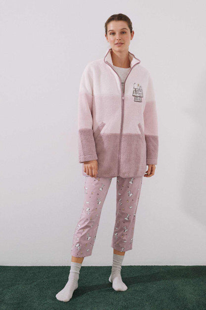 Women's fleece pajama set in pink: zip-up jacket, contrast panels, patterned pants.