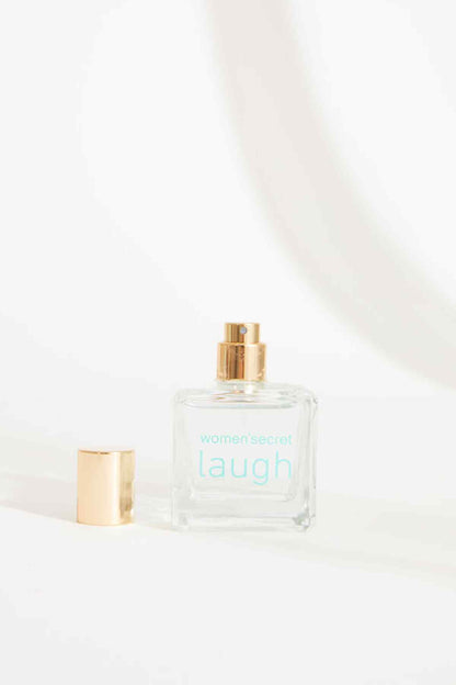 Women'secret laugh eau de parfum bottle with gold cap, clear glass and light blue label