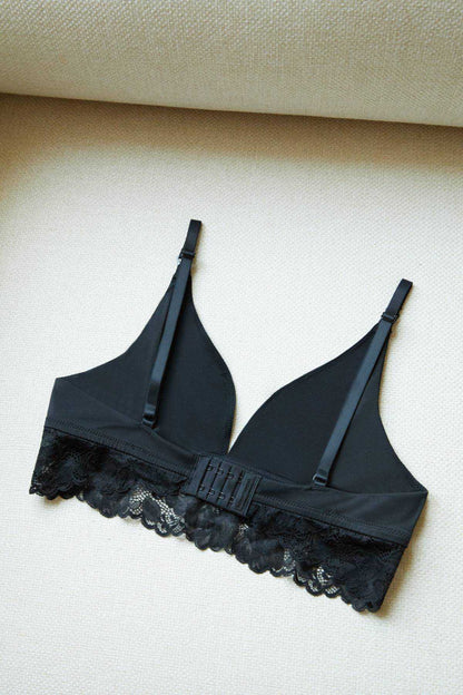 Black lace-trim bra with adjustable straps and scalloped lace hem