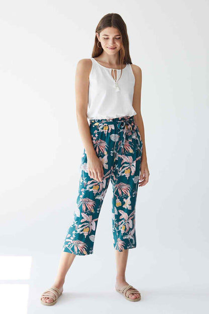 Women's sleeveless white camisole with tropical floral navy capri pants