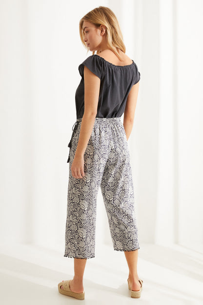 Women'secret pajama set, back view: charcoal grey top with tassel tie and floral capri pants