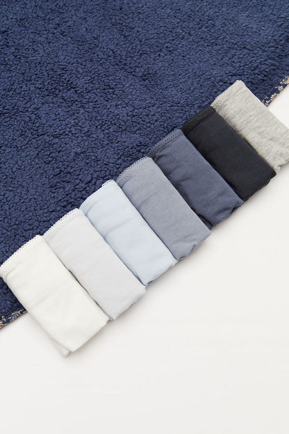 Bikini set fabric swatches folded: white, light blue, and dark blue