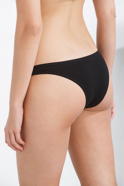 Black bikini briefs on model, low-rise hip fit