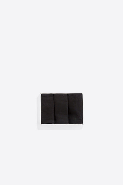 Black bikini briefs folded flat, smooth plain fabric