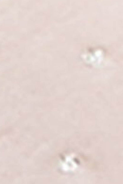 Pink plush slipper fabric detail with small dot accents