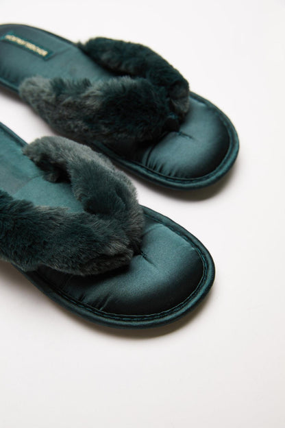 Teal slip-on slippers with dark faux-fur trim detail