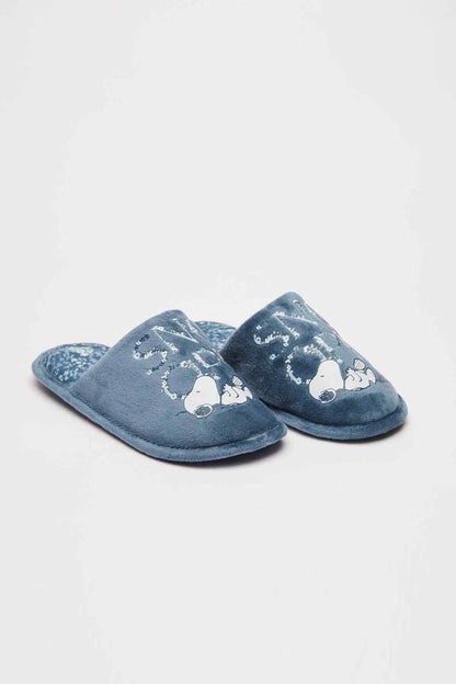 Pair of medium blue plush slip-on slippers with penguin prints and cushioned footbeds
