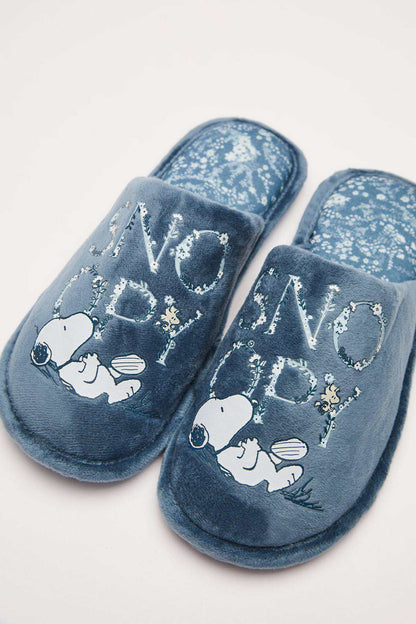 Medium blue plush slippers with penguin print pattern on the uppers
